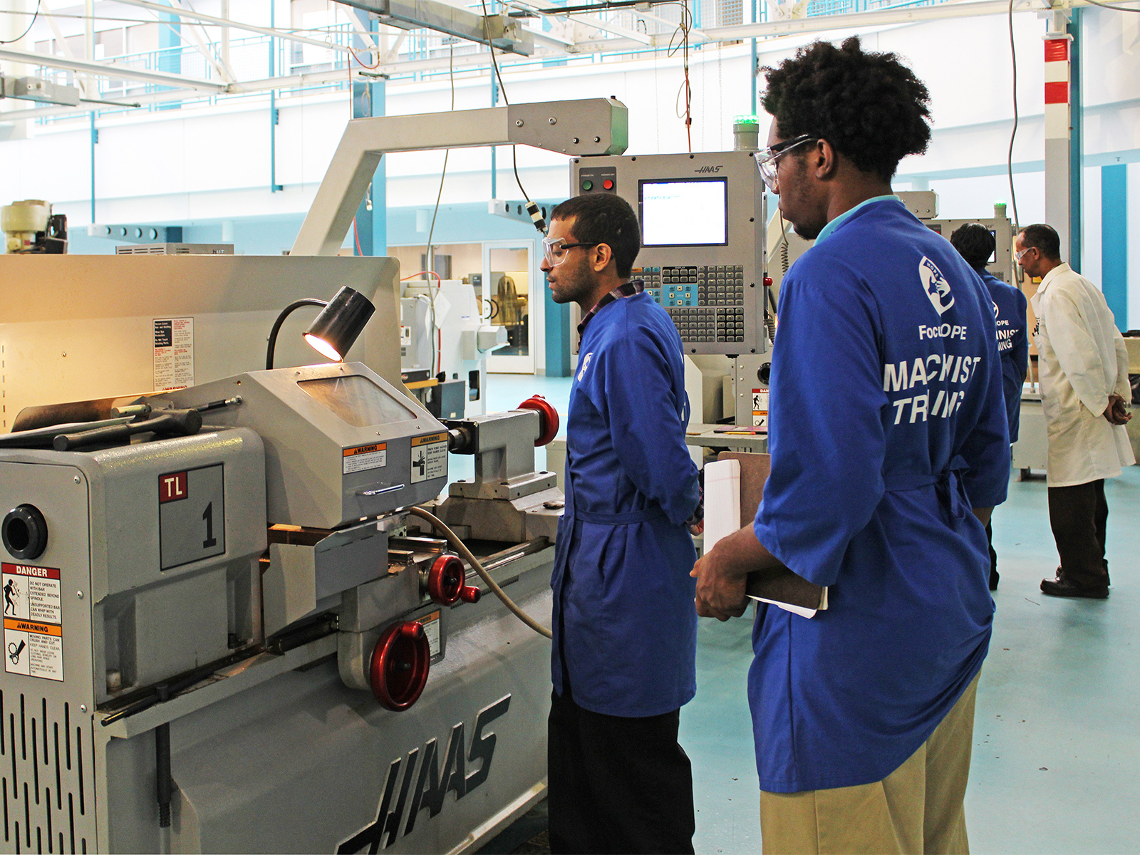 Young Men Operate Machinery at Training Center